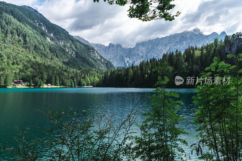 乌迪内(意大利)- 2020年4月20日:以芒加特山为背景的Superior Fusine Lake。富辛湖自然公园，塔维西奥，乌迪内省，弗里利威尼斯朱利亚，意大利。